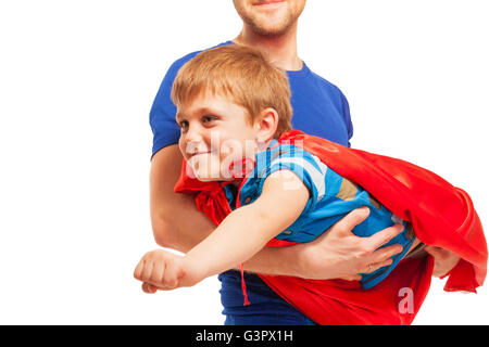 Kid boy playing superman wearing red cape Stock Photo