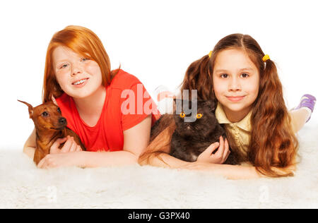 Two nice girls happy with dogs on the floor Stock Photo