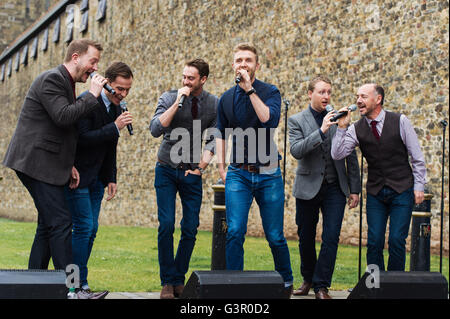 Only Men Aloud perform outside Cardiff Castle as part of the Choir Clock during Wales Millennium Centre's inaugural Festival Of Voice. Stock Photo