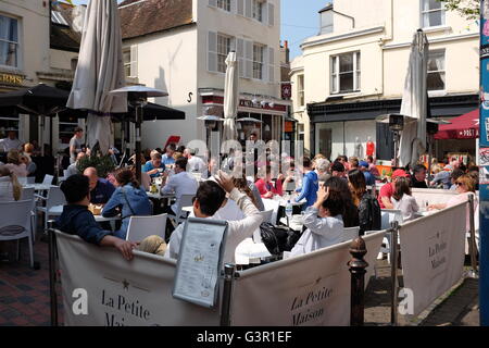 People eating and drinking outdoors alfresco style in East Street Brighton UK Stock Photo