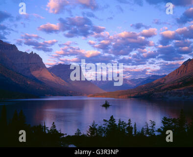 USA, Montana, Glacier National Park, Clouds from clearing storm hover over Saint Mary Lake and Wild Goose Island at sunrise. Stock Photo