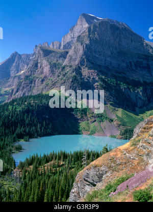 USA, Montana, Glacier National Park, Mount Gould and Angel Wing tower above Grinnell Lake which is colored turquoise by silt. Stock Photo