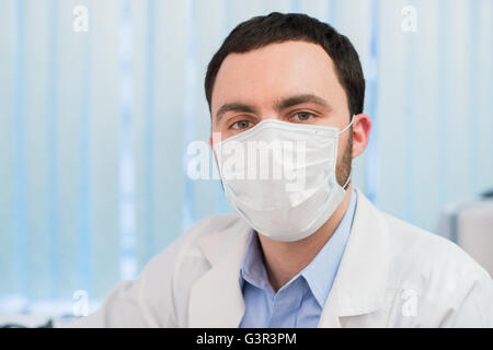 cheerful doctor with stethoscope and surgical mask Stock Photo