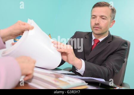 Man going through catalogue with client Stock Photo