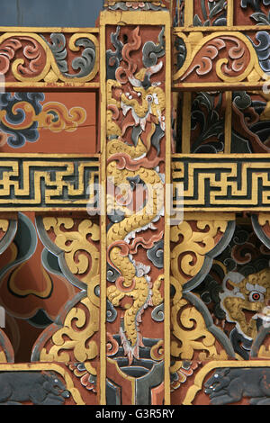 Sculpted dragon, swastikas and floral patterns decorating a rail in the Druk Wangyal Lhakhang near Thimphu (Bhutan). Stock Photo