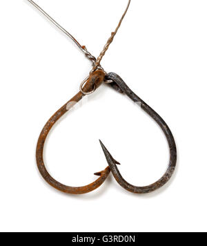 Old rusty fishhooks in form of heart. Isolated on white background. Stock Photo