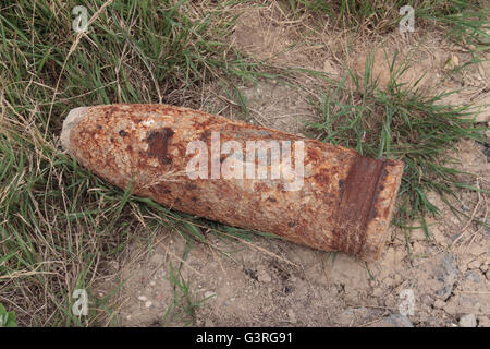 Unexploded World War One shell left on the roadside beside a field in Northern France for ultimate collection and destruction. Stock Photo