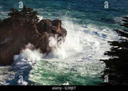 The Pacific Ocean explodes against the cliffs at Julia Pfeiffer Burns State Park on California’s Big Sur Coast. Stock Photo