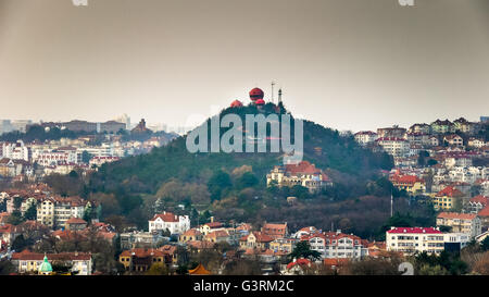 Southern side of signal hill in old town of Qingdao, red observation domes and classic Guest House on southern slope. Stock Photo