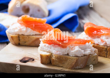 Homemade toasts with smoked salmon cream cheese dip. Best smoked salmon appetizers Stock Photo