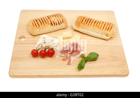 Pannini ingredients on a wooden chopping board isolated against white Stock Photo