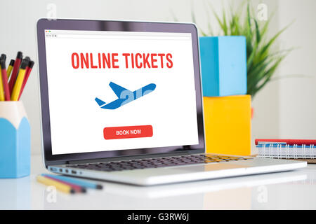 Buying airline tickets on computer Stock Photo