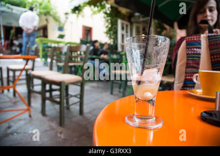 A finished traditional cold Greek coffee (freddo cappuccino) in the famous Plaka cafes on the steps. Stock Photo