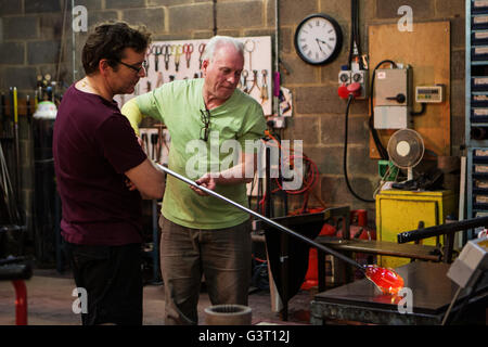 Glass blowers working in their work shop Stock Photo