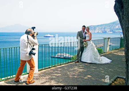 A wedding photographer with the bridal couple at Sorrento, near Naples, Italy Stock Photo