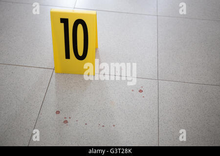 evidence marker at stain on room floor in crime scene investigation ...