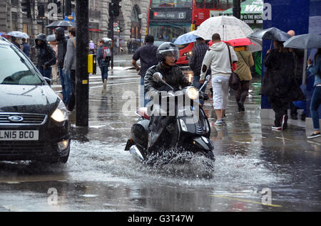 London, UK, 14 June 2016, A heavy downpour causes flooding at Piccadilly Circus in the West End Credit:  JOHNNY ARMSTEAD/Alamy Live News Stock Photo