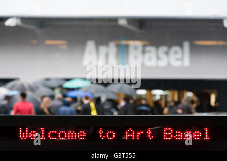 Basel, Switzerland. 14 June, 2016. Visitors are queuing up in the pouring rain outside Basel's exhibition centre at the opening of 'Art Basel 2016', one of the world's largest and most spectacular gatherings for contemporary and modern art. For the next six days, 280 galleries will show works from 4,000 artists. In 2015, the show in Basel, which also has offshoots in Hong Kong and Miami, attracted 98,000 visitors from all over the world. Credit:  Erik Tham/Alamy Live News Stock Photo