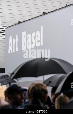 Basel, Switzerland. 14 June, 2016. Visitors are queuing up in the pouring rain outside Basel's exhibition centre at the opening of 'Art Basel 2016', one of the world's largest and most spectacular gatherings for contemporary and modern art. For the next six days, 280 galleries will show works from 4,000 artists. In 2015, the show in Basel, which also has offshoots in Hong Kong and Miami, attracted 98,000 visitors from all over the world. Credit:  Erik Tham/Alamy Live News Stock Photo