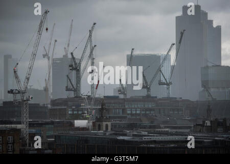 London, UK. 14th June, 2016. UK Weather: Heavy rain hit the City of London this afternoon, significantly reducing visibility and causing people to shelter themselves as best they could with umbrellas. Credit:  Guy Bell/Alamy Live News Stock Photo