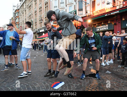 Lille, France. 14th June, 2016. A soccer fan jumps on a russian flag in the City of Lille, France, 14.06.2016. Photo: Marius Becker/dpa Credit:  dpa picture alliance/Alamy Live News Stock Photo