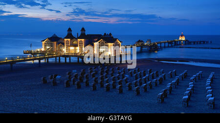 The pier in Sellin, Germany, is dipped into blue light in the evening of 14 June 2016. The striking blue is the landmark of the Baltic Sea bath on the island of Ruegen. The pier has a restaurant near the beach, sun terasses and shipping piers. The origins of the 394-metres-long pier lie in the original construction from 1906. Photo: Jens Wolf/dpa Stock Photo
