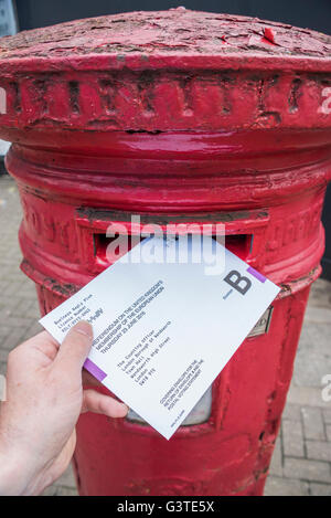 London, UK. 15th June, 2016. Posting a vote for the EU referendum in a traditional red letter box. Credit:  Guy Bell/Alamy Live News Stock Photo
