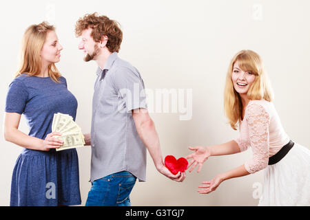 Cheating and cunning idea. Handsome sneaky man tricking rich woman for his true love. Triangle concept. Stock Photo