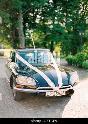 Sweden, Halland, Vintage car decorated with wedding ribbons Stock Photo