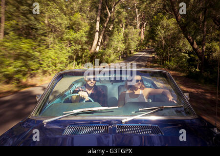 Australia, New South Wales, Sydney, Lane Cove, Couple driving car through forest