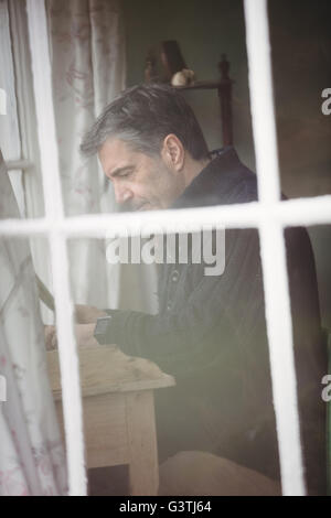 Profile of mature man working with laptop Stock Photo