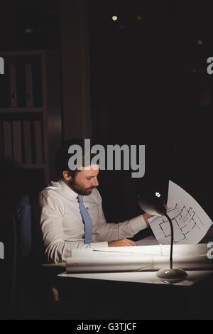 Overworked businessman working at night Stock Photo