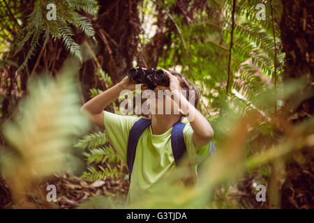 Little boy looking through binoculars Stock Photo