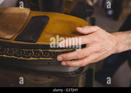 Close up of hand holding a shoe Stock Photo