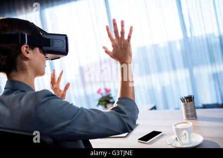Businesswoman using an oculus Stock Photo