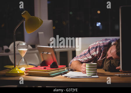 Hipster sleeping on desk Stock Photo