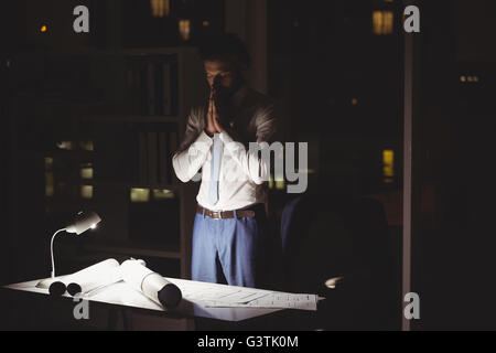 Overworked businessman working at night Stock Photo