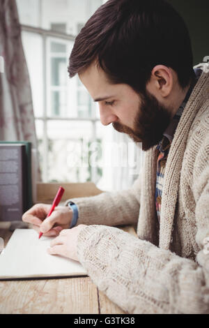 Profile of man writing in a notebook Stock Photo - Alamy