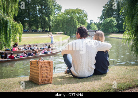Friends enjoying a picnic on the banks of the River Cam in Cambridge. Stock Photo