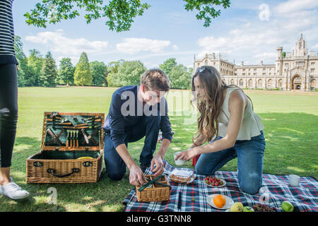Friends enjoying a picnic on the banks of the River Cam in Cambridge. Stock Photo