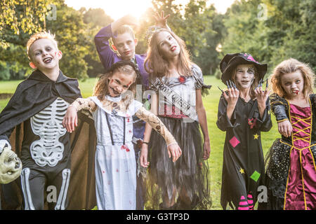 Children pose in zombie costumes for Halloween Night. Stock Photo