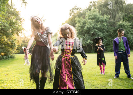 Two children dressed in costume for Halloween Night. Stock Photo
