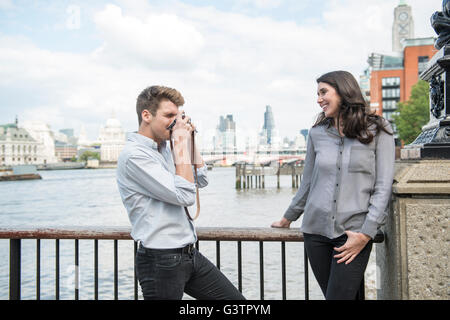 https://l450v.alamy.com/450v/g3tpym/a-young-couple-taking-photographs-on-the-south-bank-in-london-g3tpym.jpg