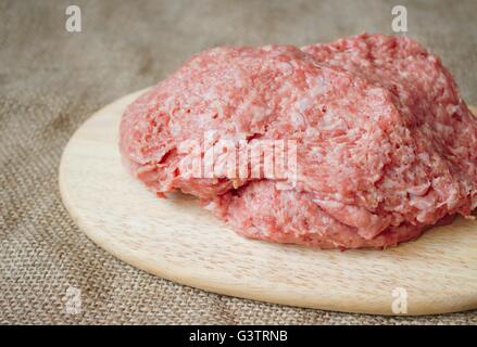 the ball of raw chicken meatloaf on the wooden board. Stock Photo