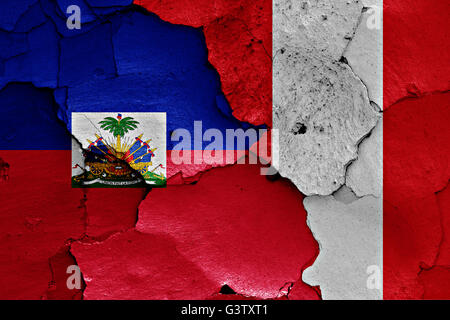 flags of Haiti and Peru painted on brick wall Stock Photo