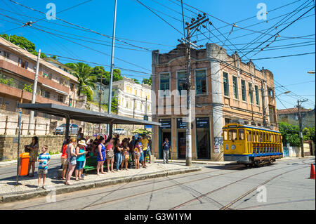 RIO DE JANEIRO - MARCH 28, 2016: Tourists ride the new version of the iconic bonde tram near Largo dos Guimarães in Santa Teresa Stock Photo