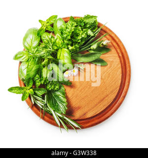 Herbs on cutting board. Fresh basil, parsley, sage, peppermint and rosemary bunch. Single object isolated on white background Stock Photo