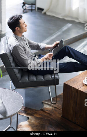 Young man using digital tablet in office Stock Photo