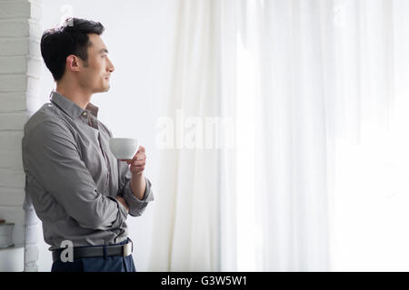 Young man drinking coffee Stock Photo