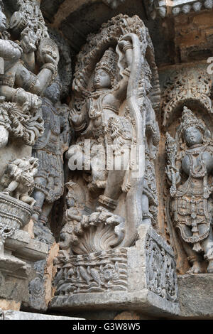 Ornate wall panel reliefs depicting Krishna dancing on the head of serpent Kalia. Kedareshwara temple, Halebid, Karnataka, India Stock Photo